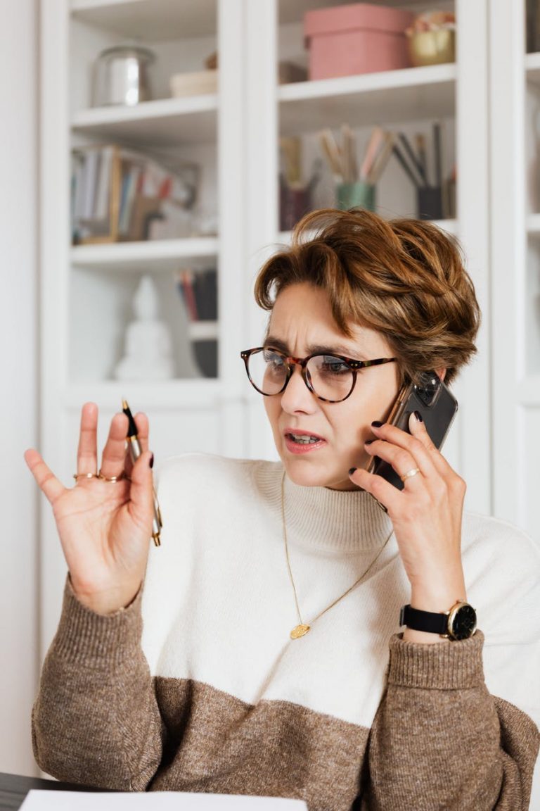 woman talking on phone with confused face