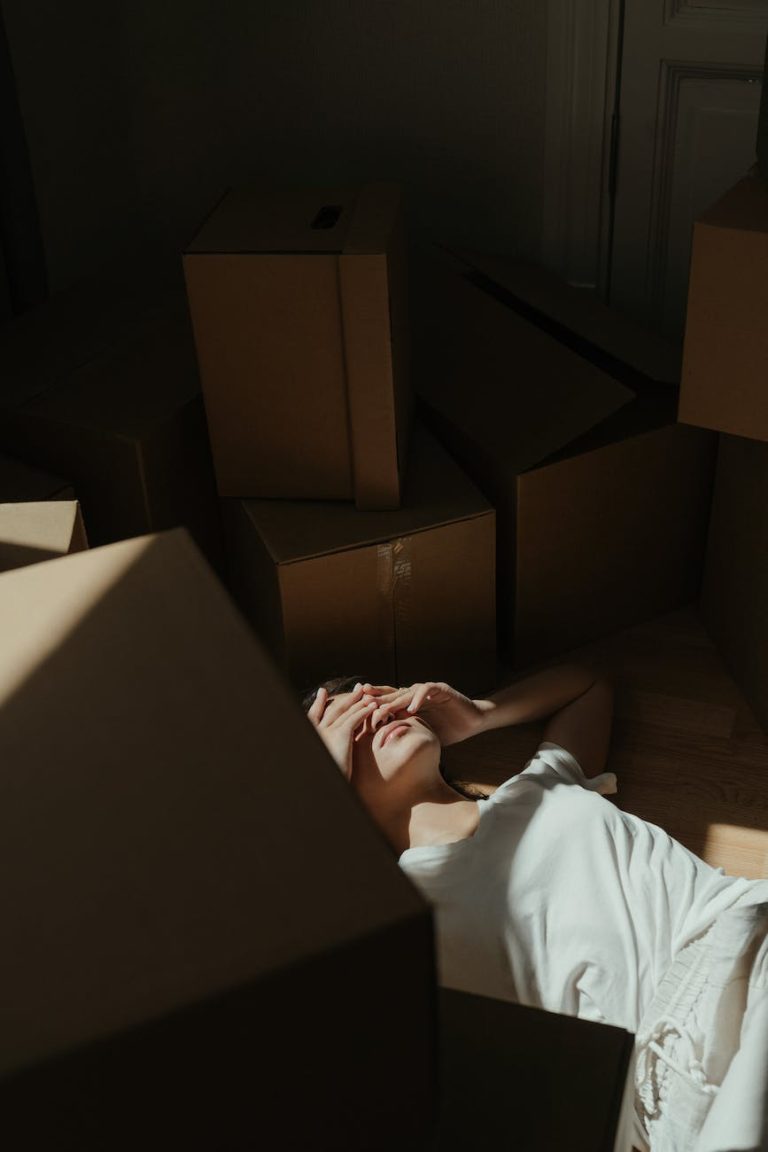 person in white shirt lying on brown wooden bed