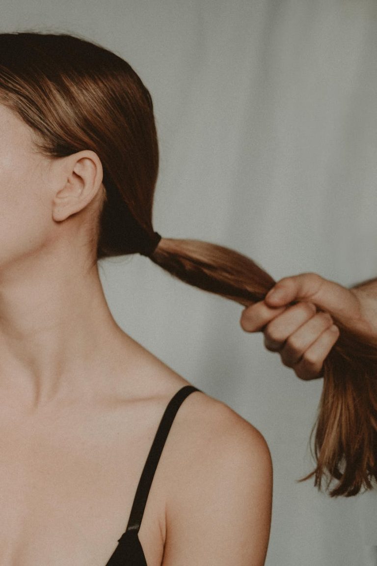 crop man pulling hair of woman