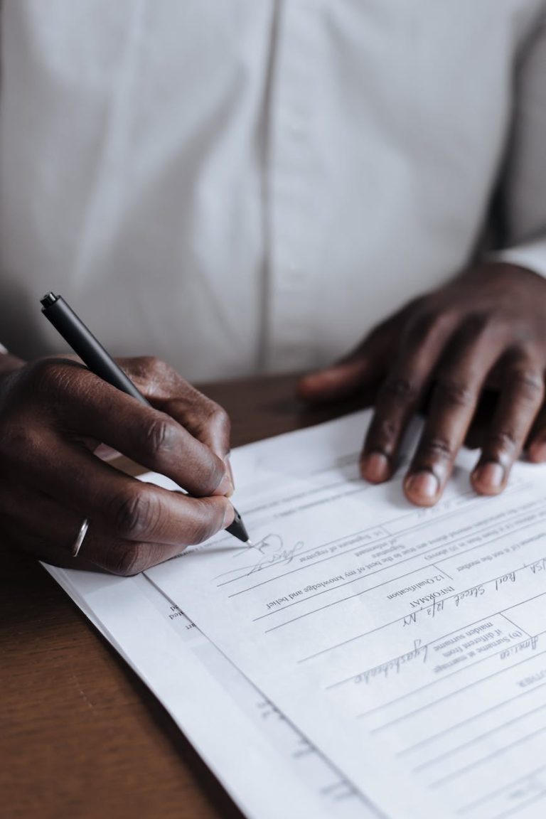 unrecognizable men signing adoption document