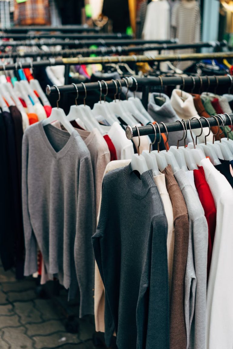 clothes on hangers hanging on clothing racks