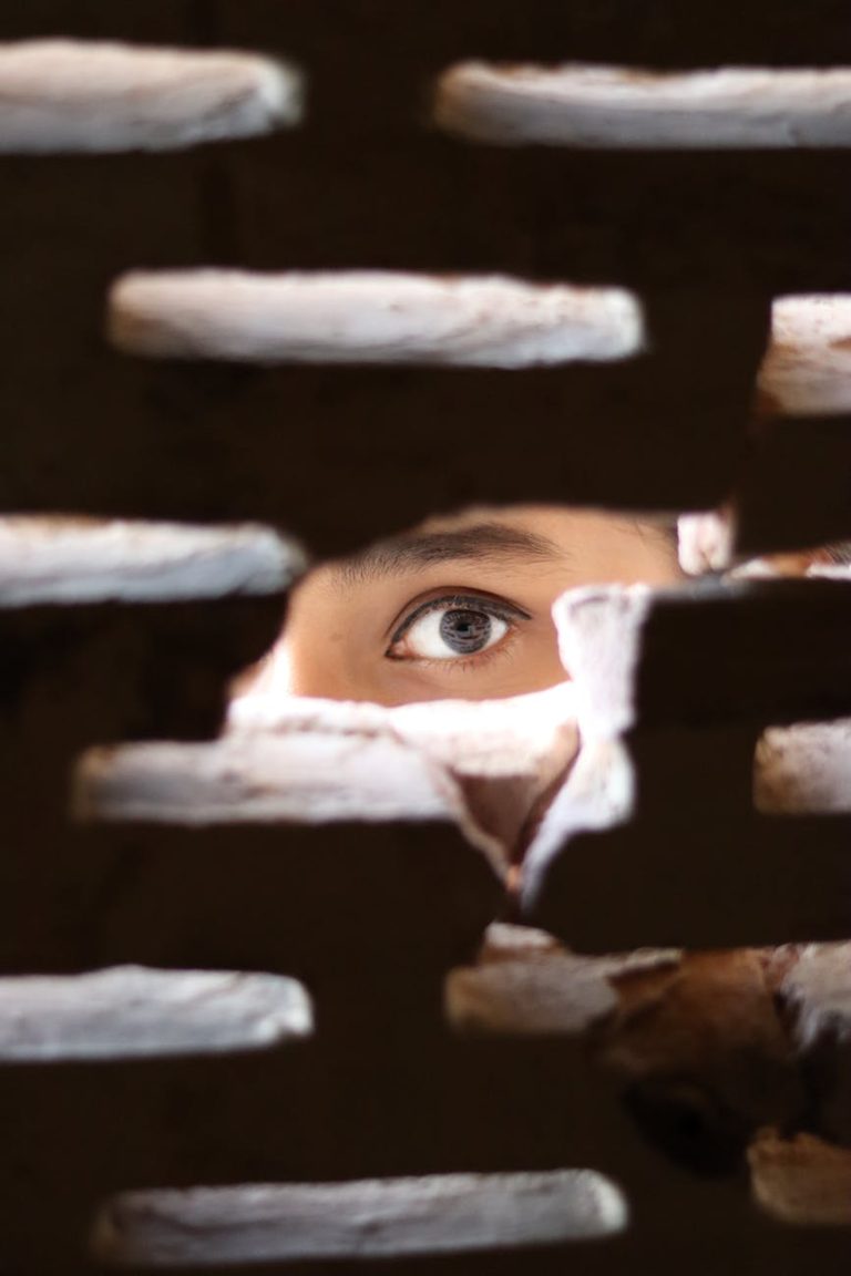 photo of person peeking through the hole
