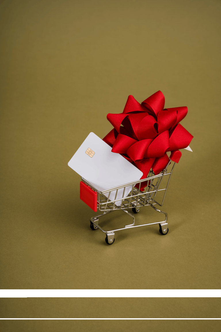 miniature shopping trolley with a red ribbon and a chip card