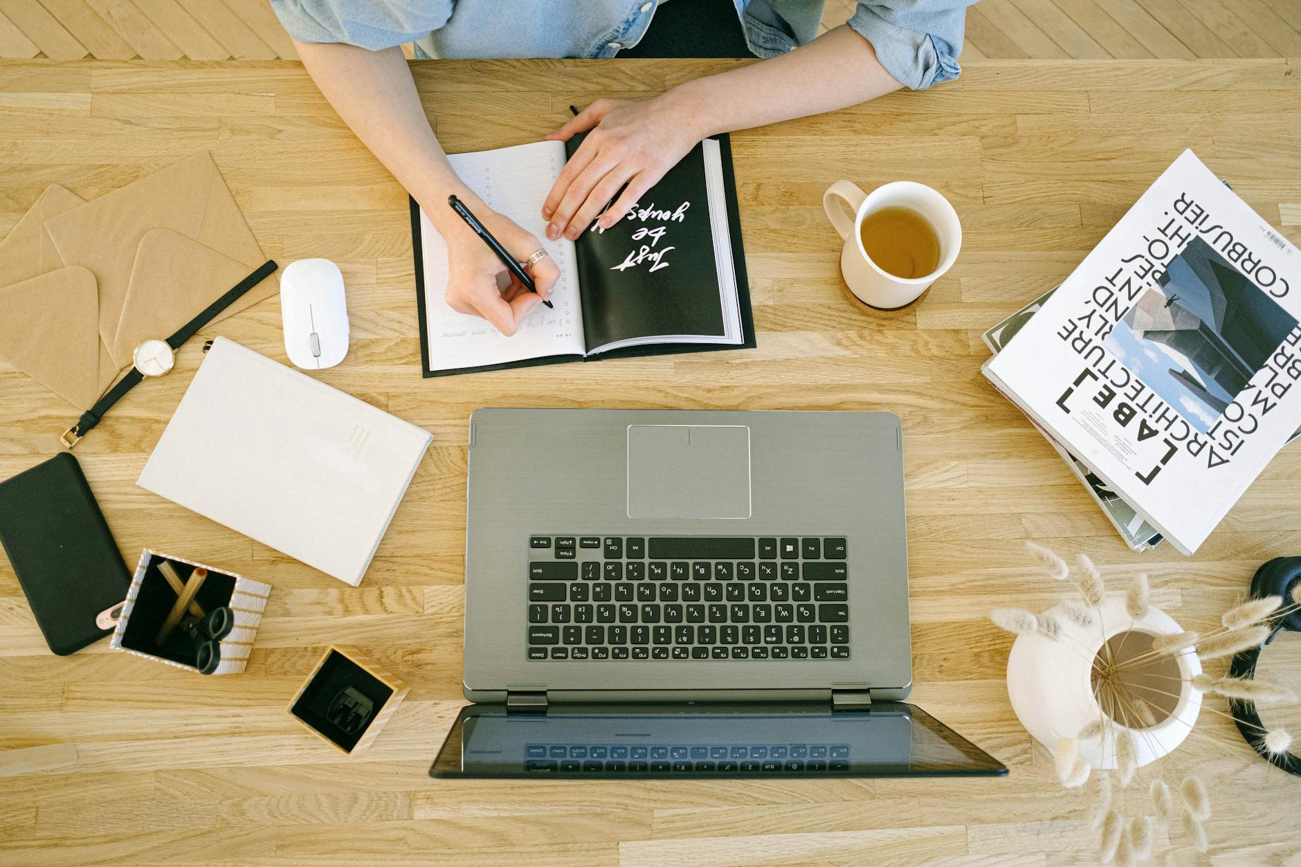 high angle view of woman writing in notebook